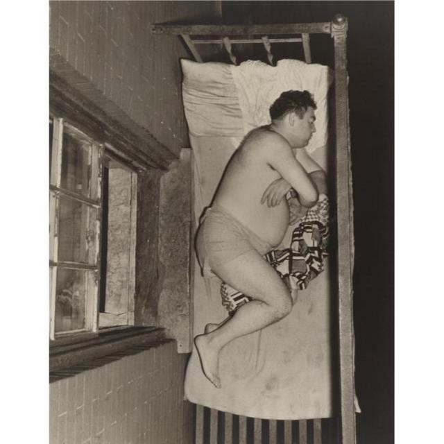 Weegee-1943-Man Sleeping on a Fire Escape