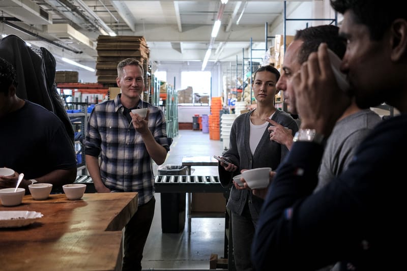 A group of people sipping coffee at the coffe roastery