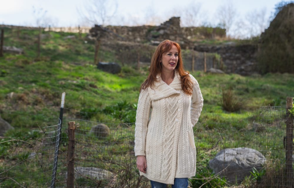 Portrait of a woman in a beige sweater at the Irish Hunger Memorial