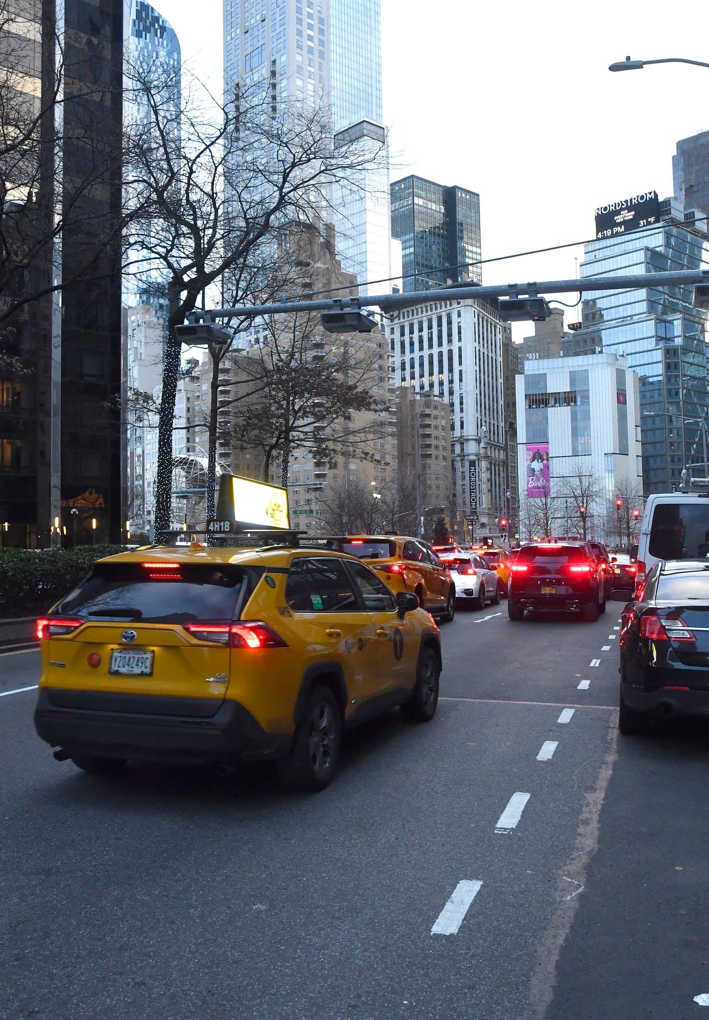 A taxi and other cars drive under a license plate scanner in Manhattan