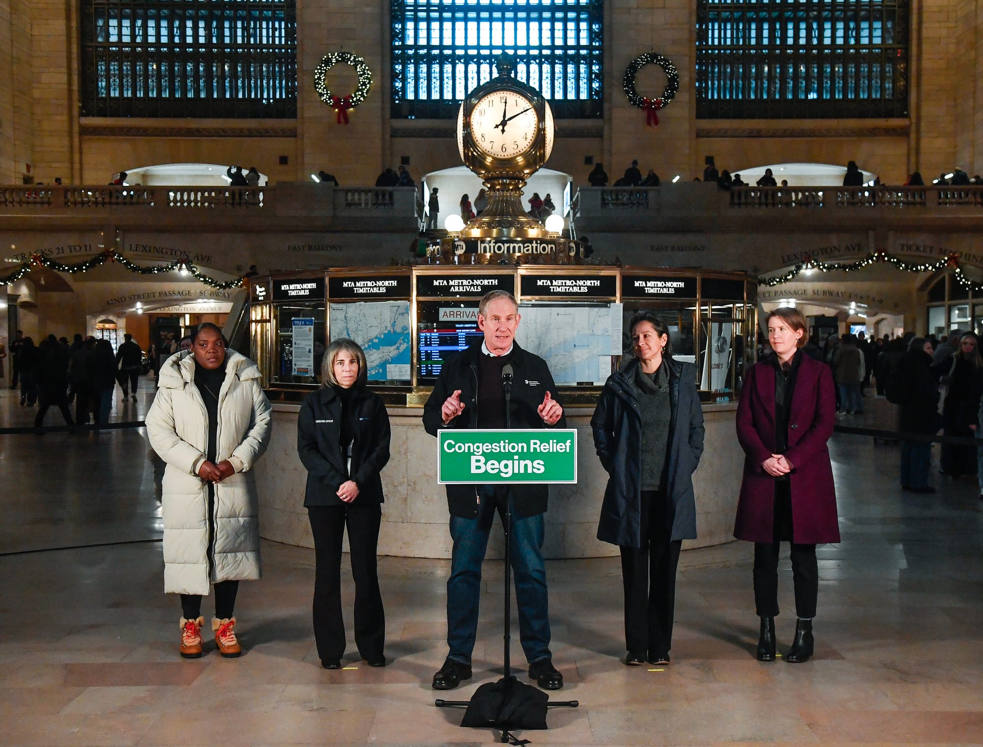 MTA Chief Customer Service Officer Shanifah Rieara, MTA Bridges & Tunnels Chief Operating Officer Allison C. de Cerreño, MTA Chair & CEO Janno Lieber, MTA Deputy Chief of Policy & External Relations Juliette Michaelson, MTA Chief of Staff Laura Wilesin main concourse of Grand Central Terminal in Front of microphone with a green sign that reads "Congestion Relief Begins"