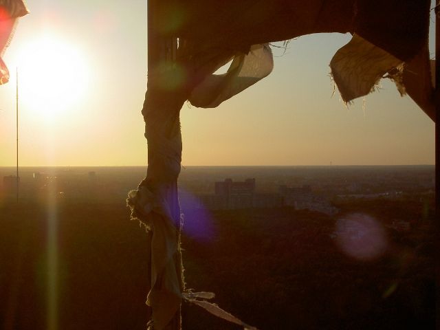 sunset caught through the torn canvas of the main tower