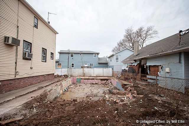 Debris has been cleared from this lot, only a painted foundation remains.