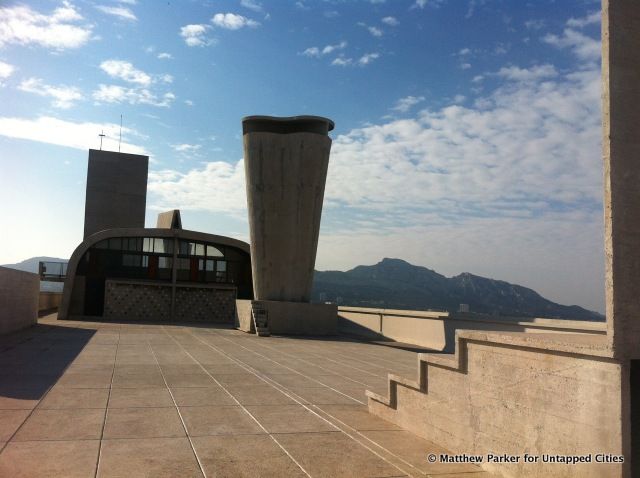 Curvaceous chimney against the mountains of Marseille