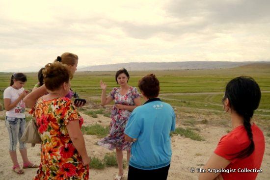 The art group and historian near Taraz on an ancient city ruin.