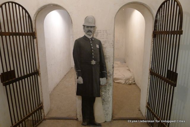 Jail cells still show names and dates etched into the walls.