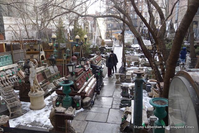 The back garden with outdoor ornaments,, clocks, wrought iron, gates & lighting