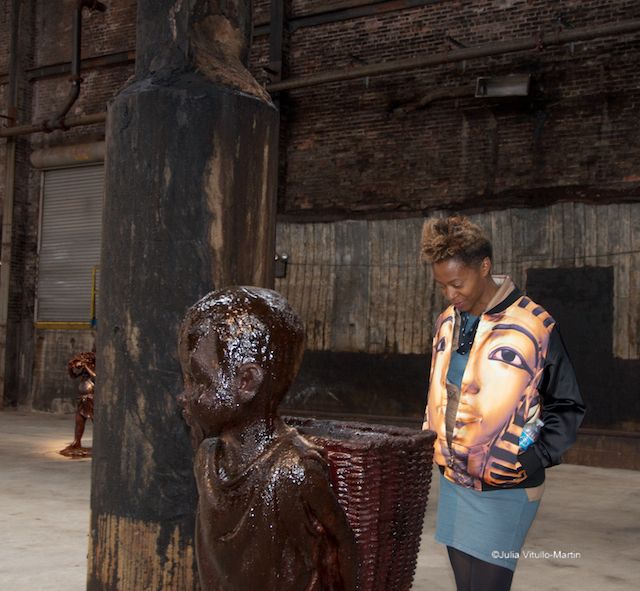 Kara Walker pondering one of her candy slave-boy sculptures