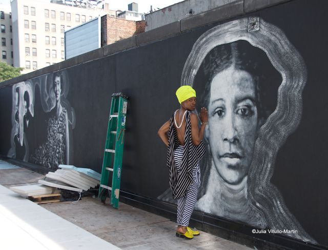 Creative Director Soleo in front of Raúl Ayala's murals of great black writers