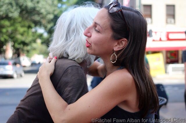 A life-long resident offers emotional support to Powers, who is visibly upset.