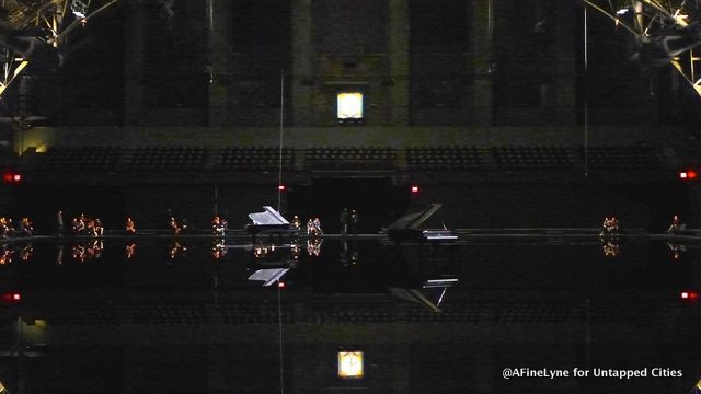 A Steinway Grand Piano and Computerized Piano are reflected in the pool