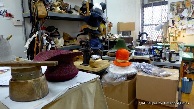 Mr. Bunn's work room is filled with fabric, ribbon and hats in every stage of creation