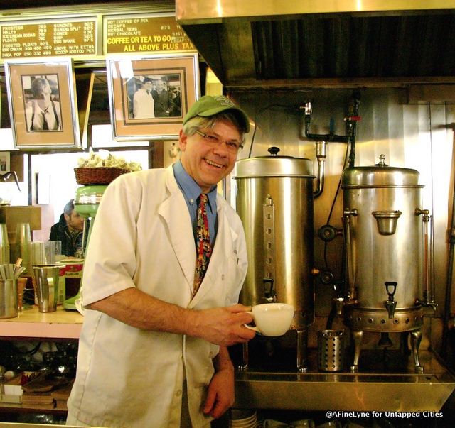 The owner, John, getting a cup of coffee from their coffee urn c.1948