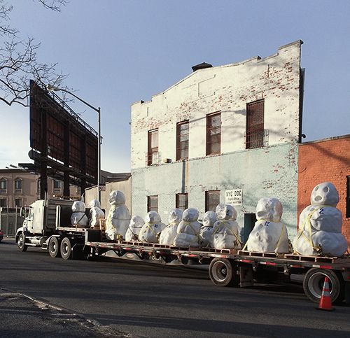 Twelve snowmen in various stages of melting, created out of marble