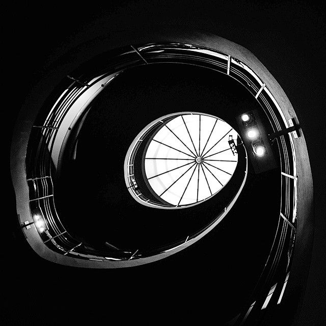 UntappedCities BigScreen Instagram Contest Photo, spiral staricase, blakc and white, NYC photography, looking up, dark, castle stairs, twited stairs