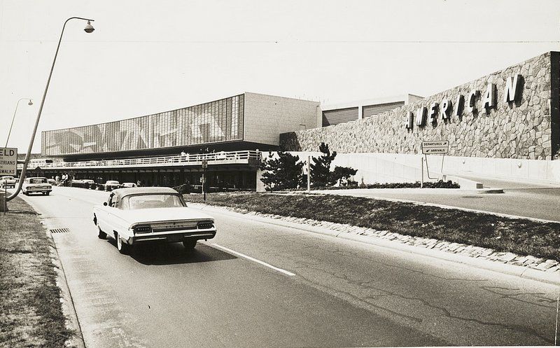 A vintage car pulls up to the former American Airlines Terminal