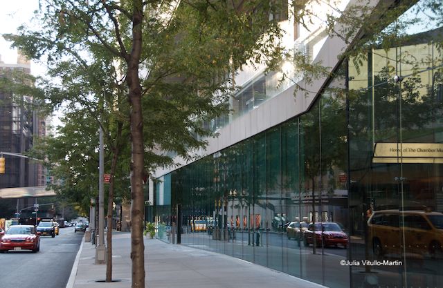 Tully's complex glass wall reflects traffic on 65th Street.