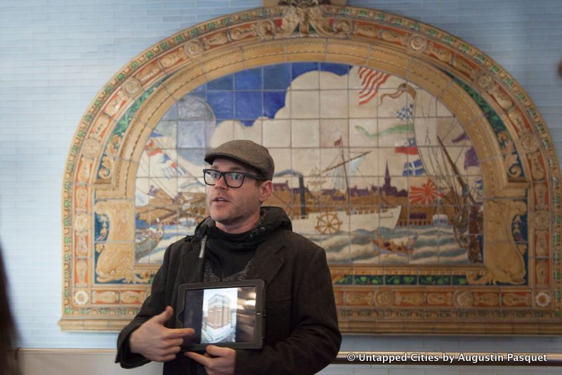 Tour guide standing in front of subway art