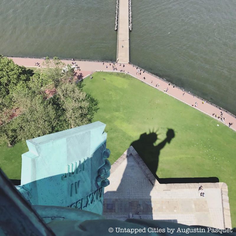 Statue of Liberty crown view of the statue's shadow on the ground below