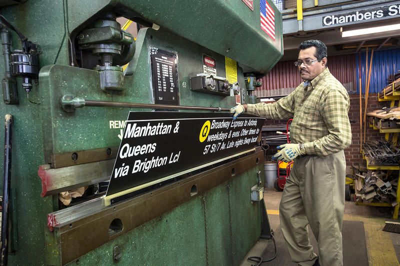 Working on subway signs in Brooklyn