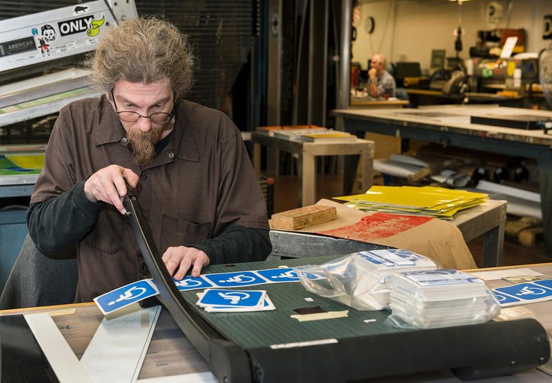 Working on subway signs in Brooklyn