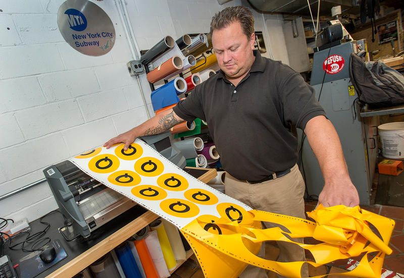 Working labels for subway signs in Brooklyn