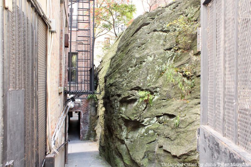 rock stuck between two buildings on 114th Street