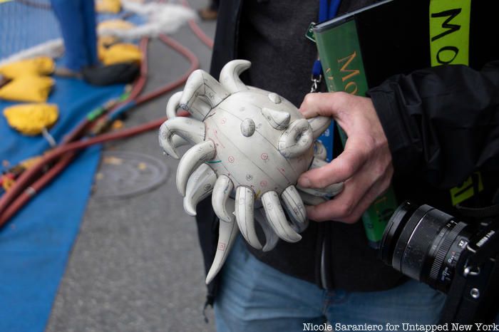 A balloon technician holds a mini 3D printed model of Yayoi Kusama’s Love Flies Up to the Sky