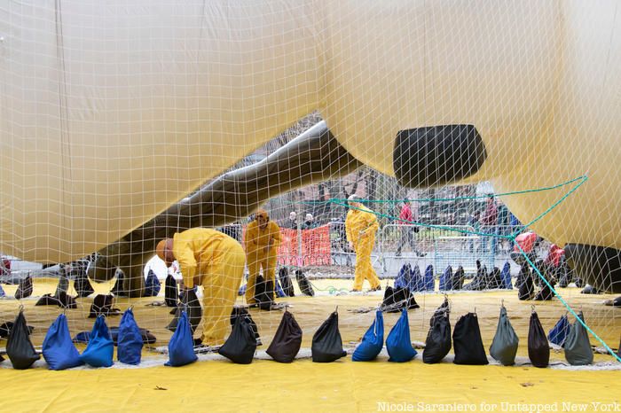 Crew workers weigh down the Olaf balloon ahead of the Macy's Thanksgiving Day Parade