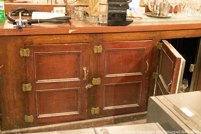 The original wood covered refrigerator behind the bar at Gage and Tollner