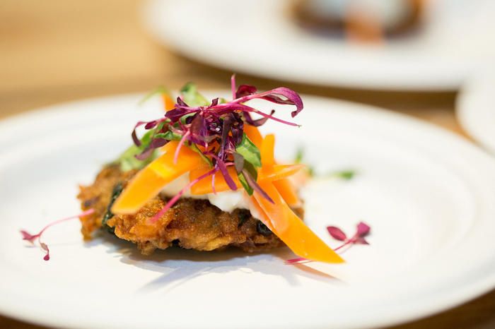 A fancy potato latke with garnish on top