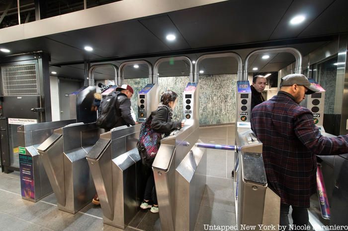 Turnstiles before the Arches of Penn Station mosaic by Diana Al Hadid