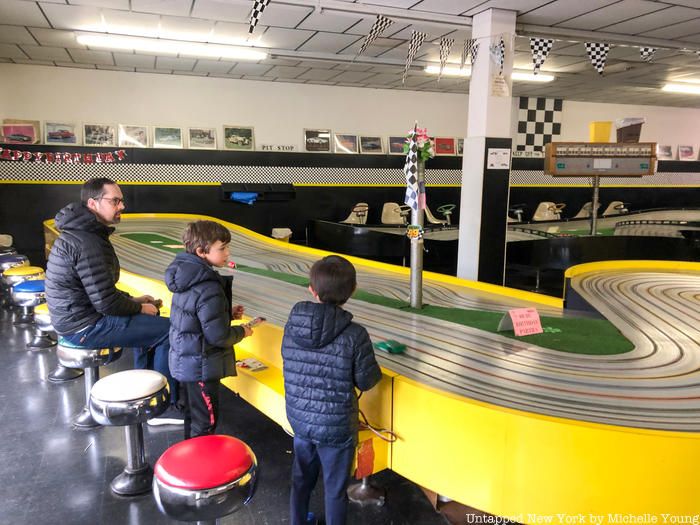 Children and father at Buzz-a-Rama slot car raceway in Kensington Brooklyn