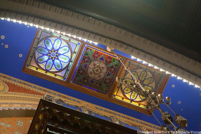 Three panels of stained glass above the ark