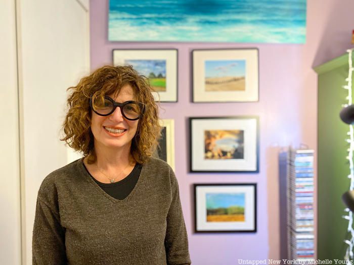 Gayle Kirschenbaum in front of her photography