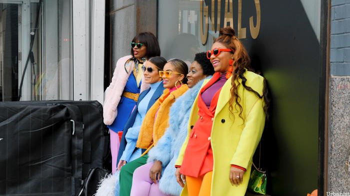 Colorfully dressed women posting in Garment District