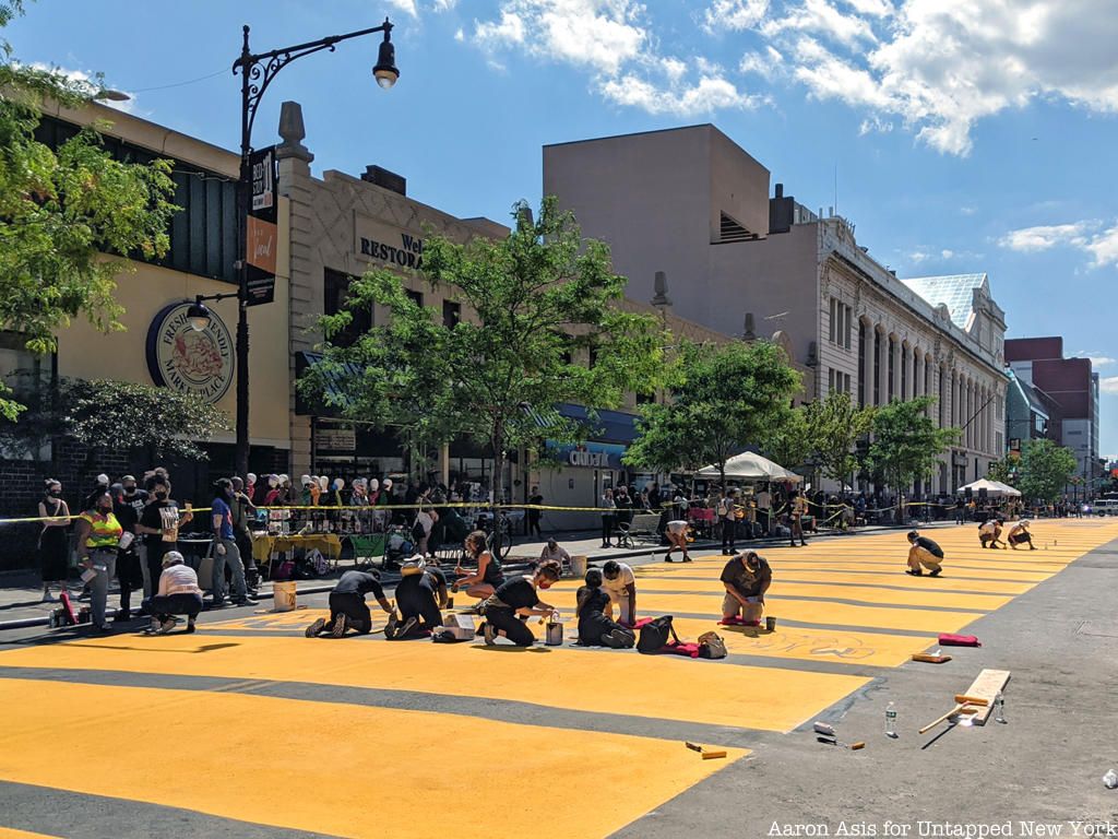 Volunteers Painting Black Lives Matter mural from a distance