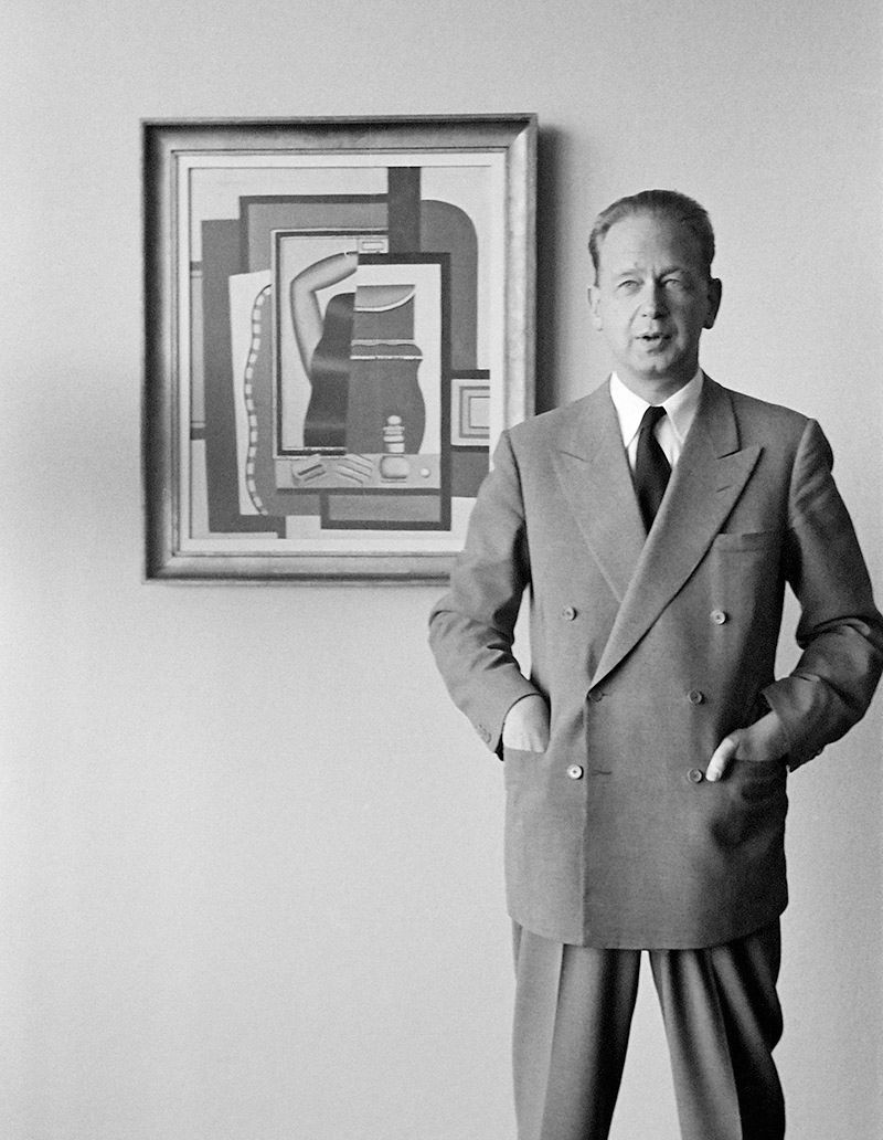 Secretary-General Dag Hammarskjöld photographed in his private apartment on the 38th floor of the Secretariat building, at United Nations Headquarters, standing in front of "Woman Combing Her Hair," a painting by Fernand Leger, lent to the United Nations by New York's Museum of Modern Art.