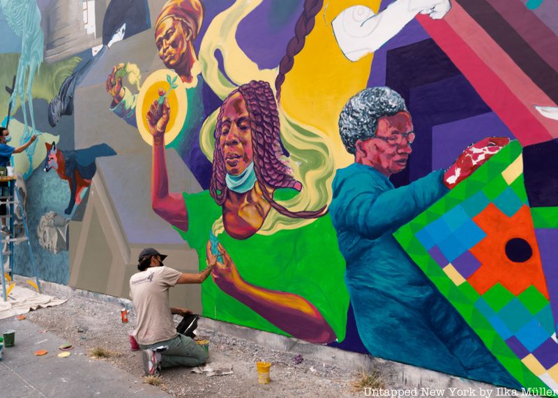 man painting bowery graffiti wall by Mojo