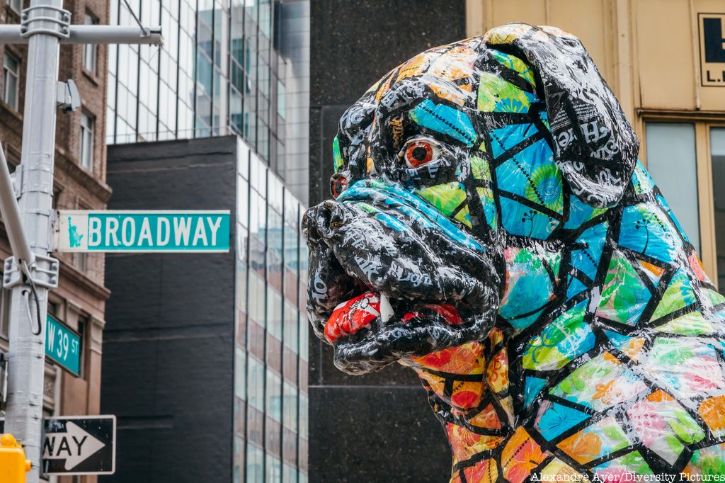 Dog sculpture with Broadway sign in back