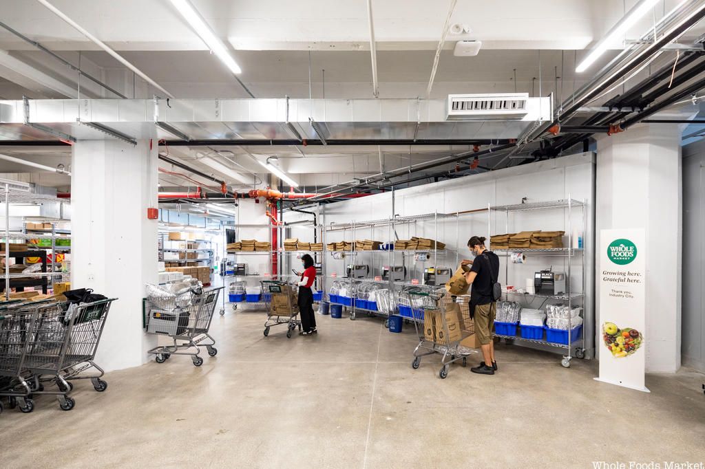 Shoppers with carts at Whole Foods Online Only Store in Industry City