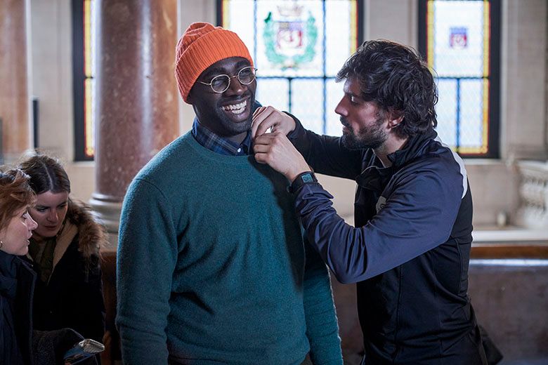 Omar Sy getting microphone set up inside filming location for Lupin in Marie 3eme