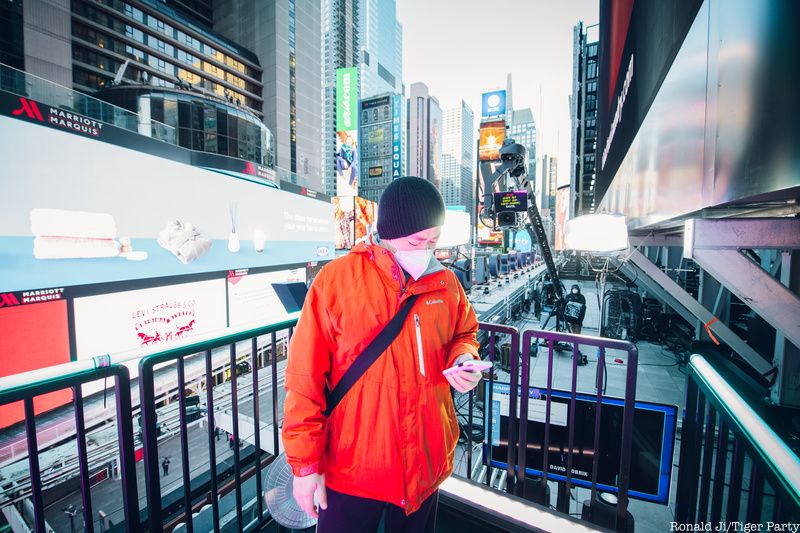 Rafale Chang monitoring the digital billboards and signs in Times Square