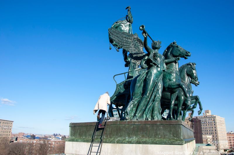 Michelle Young climbing up to the statues atop the arch