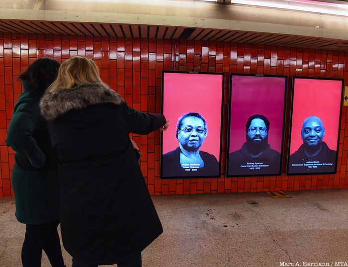 Women pointing at digital panel of TRAVELS AFAR