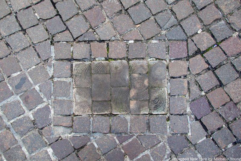 Wood Marker on Wall Street akin to the wooden sidewalk of the past