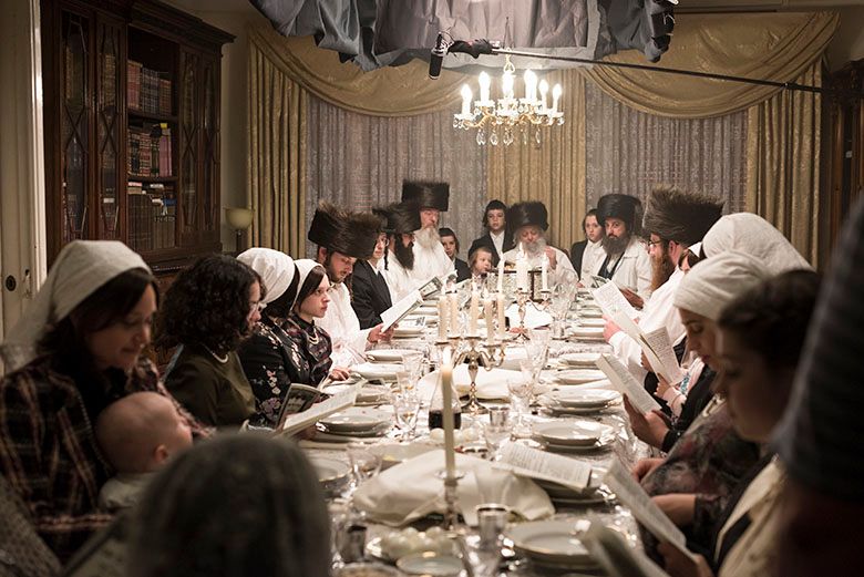 Dining table scene in Unorthodox with rabbis