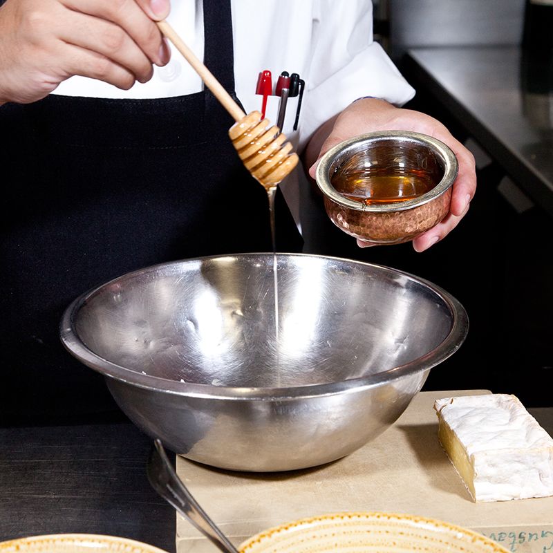 Chef making dish at French Cheese Board