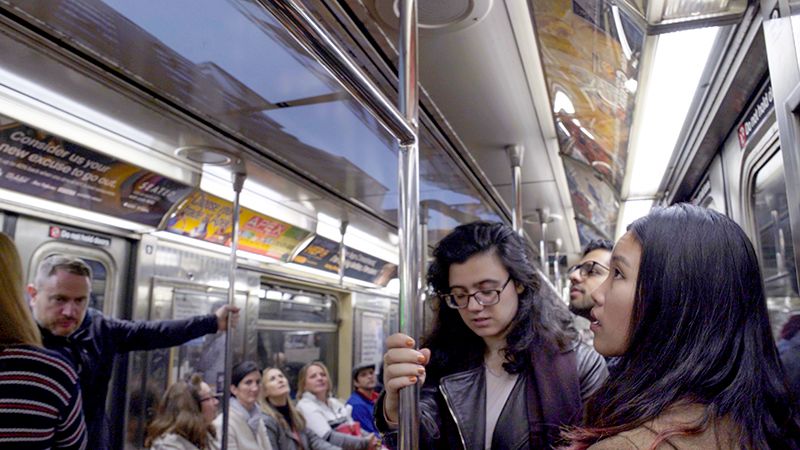 Subway riders viewing Uptown Underground 