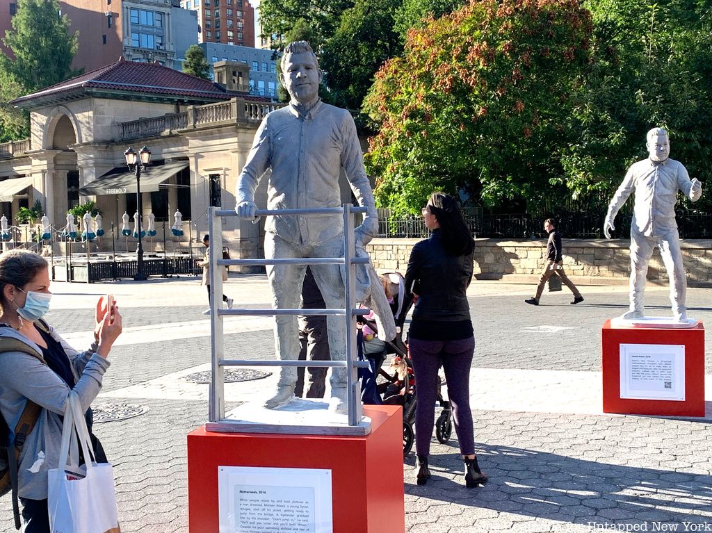 Woman taking photo of Protector Monuments with Mohsen Alwais stastue